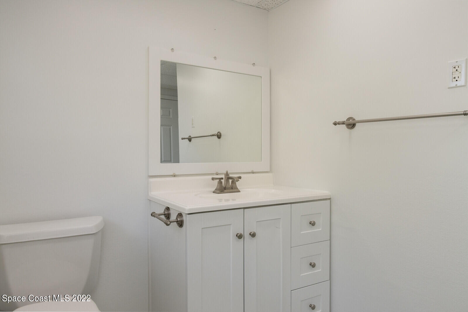 216 Dubber Road Melbourne, FL 32901 - Photo 35 of 39 a bathroom with a sink toilet and vanity