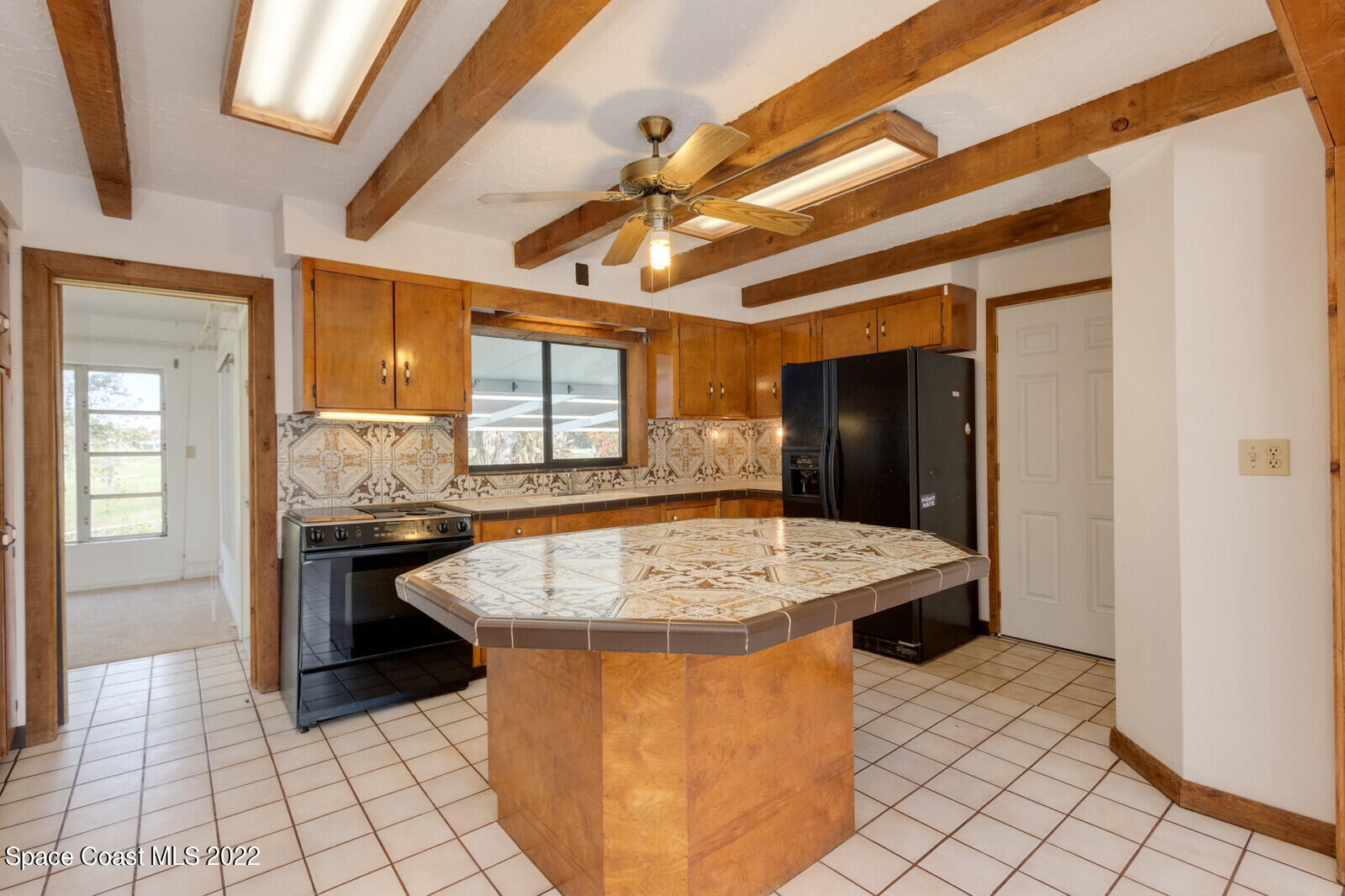 216 Dubber Road Melbourne, FL 32901 - Photo 6 of 39 a kitchen with a stove a sink and a refrigerator