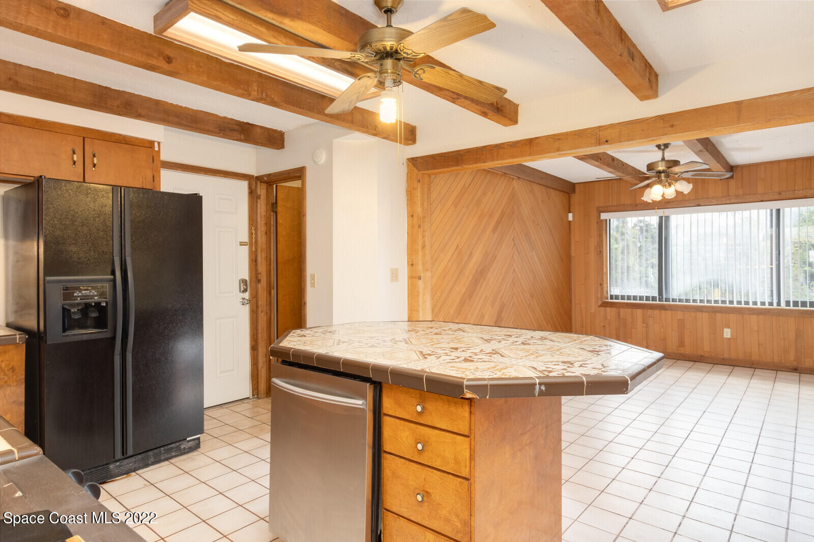 216 Dubber Road Melbourne, FL 32901 - Photo 9 of 39 a kitchen with a sink a refrigerator and chandelier