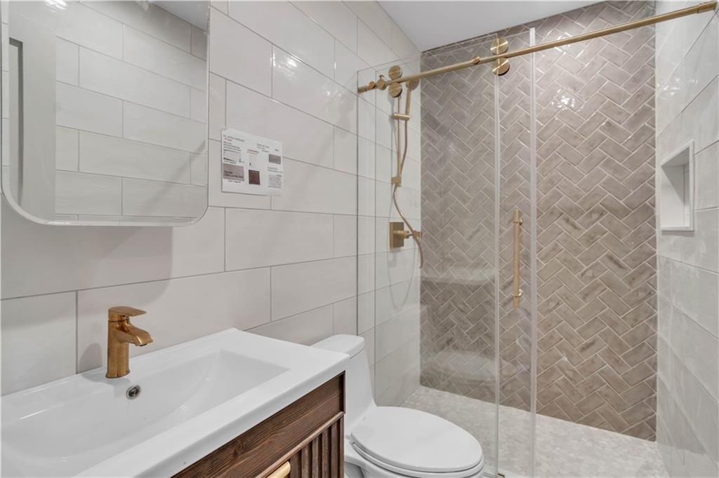 372 92nd Street, Unit 1B Brooklyn, NY 11209 - Photo 17 of 19 a bathroom with a sink toilet and shower