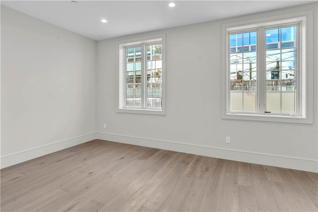 372 92nd Street, Unit 1B Brooklyn, NY 11209 - Photo 8 of 19 an empty room with wooden floor and windows