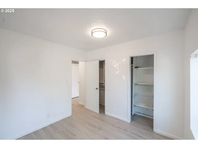 a room with closet and wooden floor