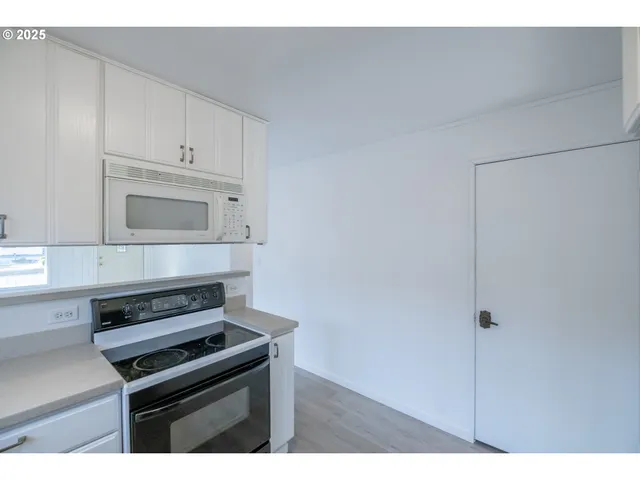 a kitchen with stainless steel appliances a refrigerator and a stove top oven