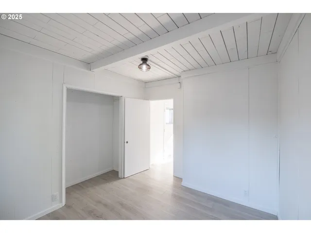 a view of hallway with wooden floor