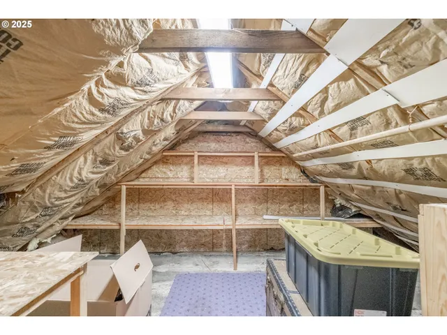 a view of an empty room and wooden floor