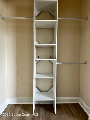 a room with wooden floor and a cabinet