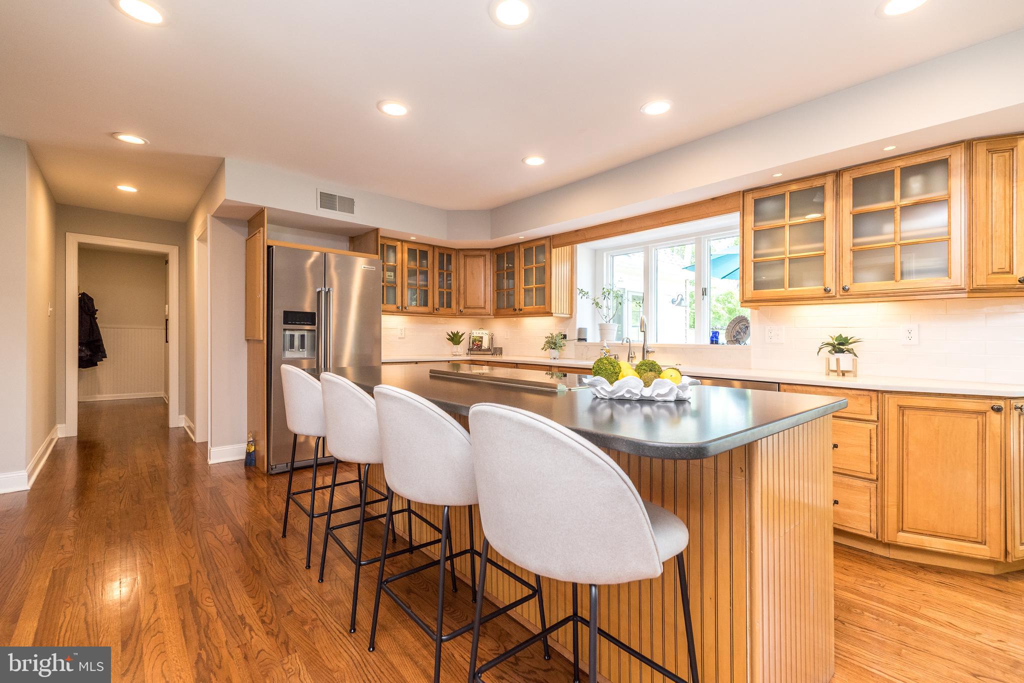 4976 Gloucester Drive Doylestown, PA 18902 - Photo 15 of 68 a kitchen with stainless steel appliances granite countertop a refrigerator a sink dishwasher and a dining table with chairs
