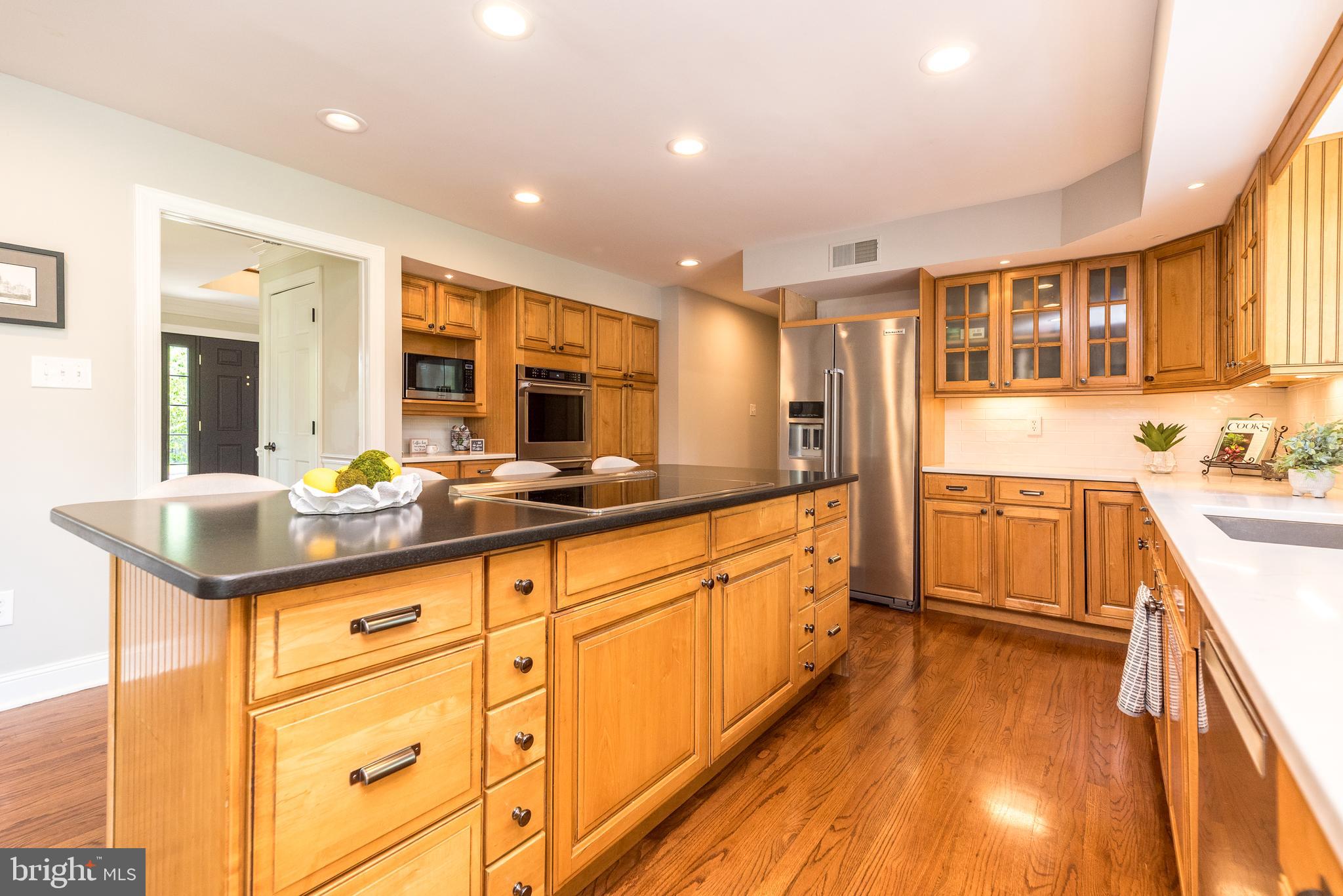 4976 Gloucester Drive Doylestown, PA 18902 - Photo 19 of 68 a large kitchen with kitchen island granite countertop a large window and white cabinets