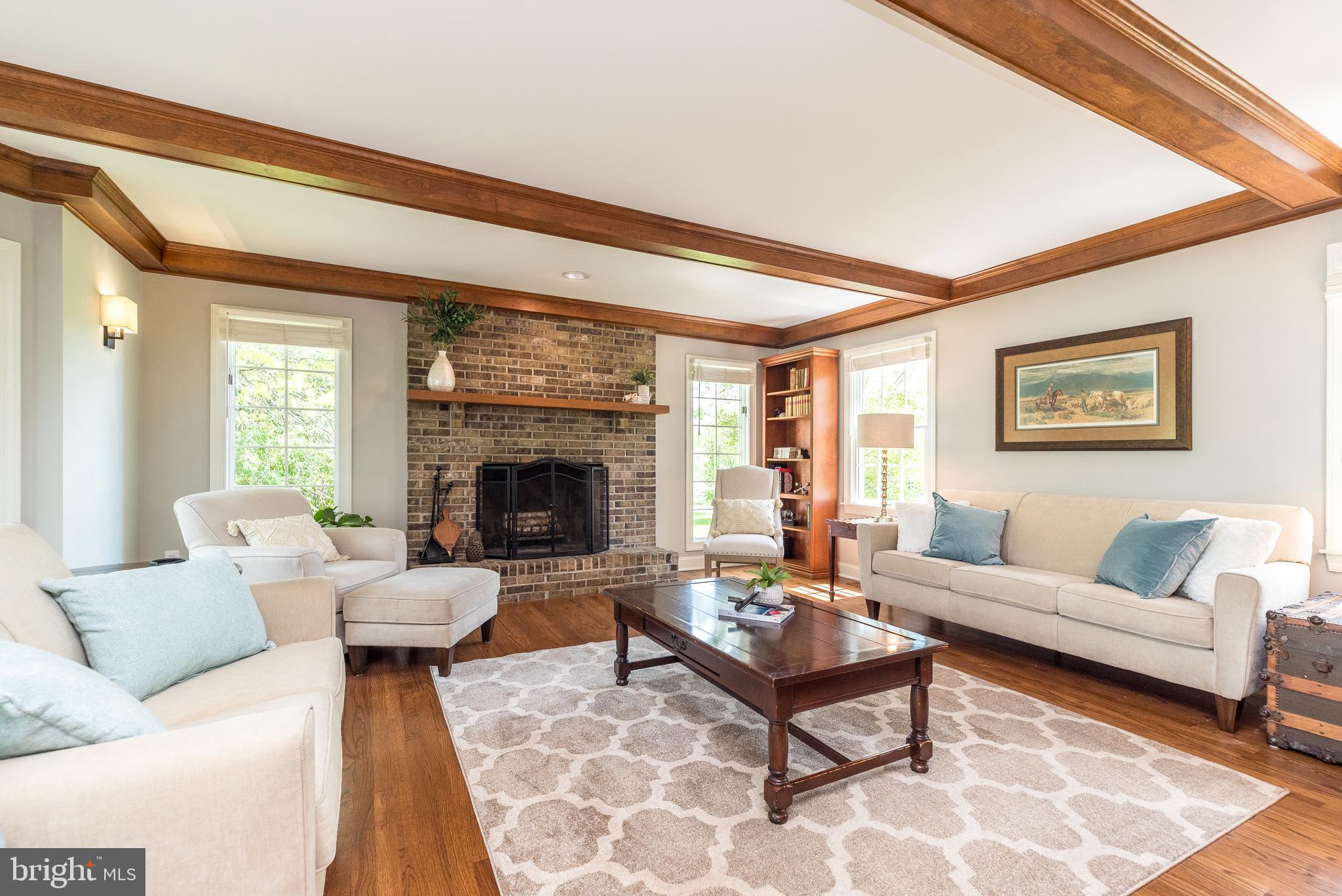 4976 Gloucester Drive Doylestown, PA 18902 - Photo 23 of 68 a living room with furniture a rug and a fireplace