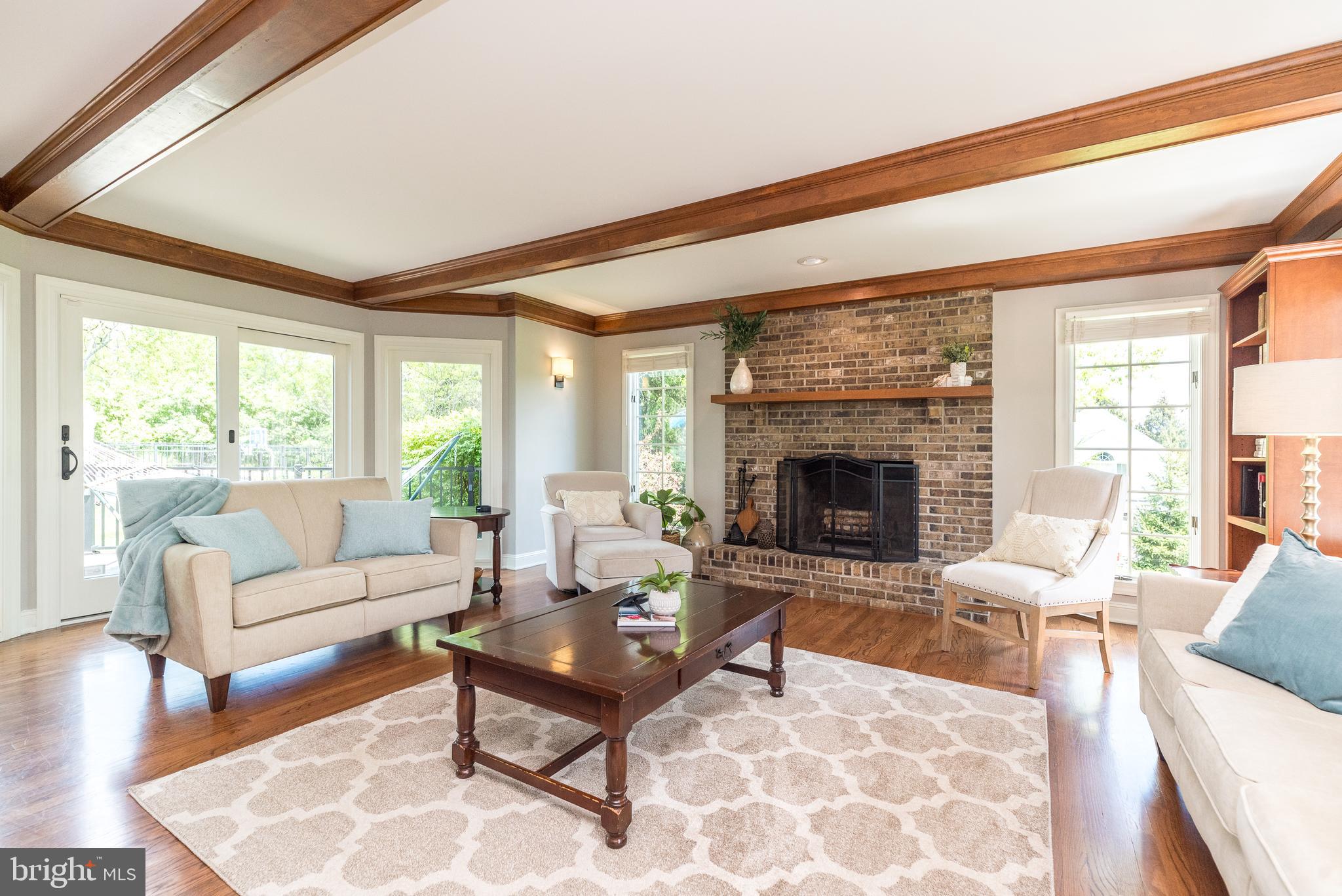 4976 Gloucester Drive Doylestown, PA 18902 - Photo 24 of 68 a living room with furniture a fireplace and a table