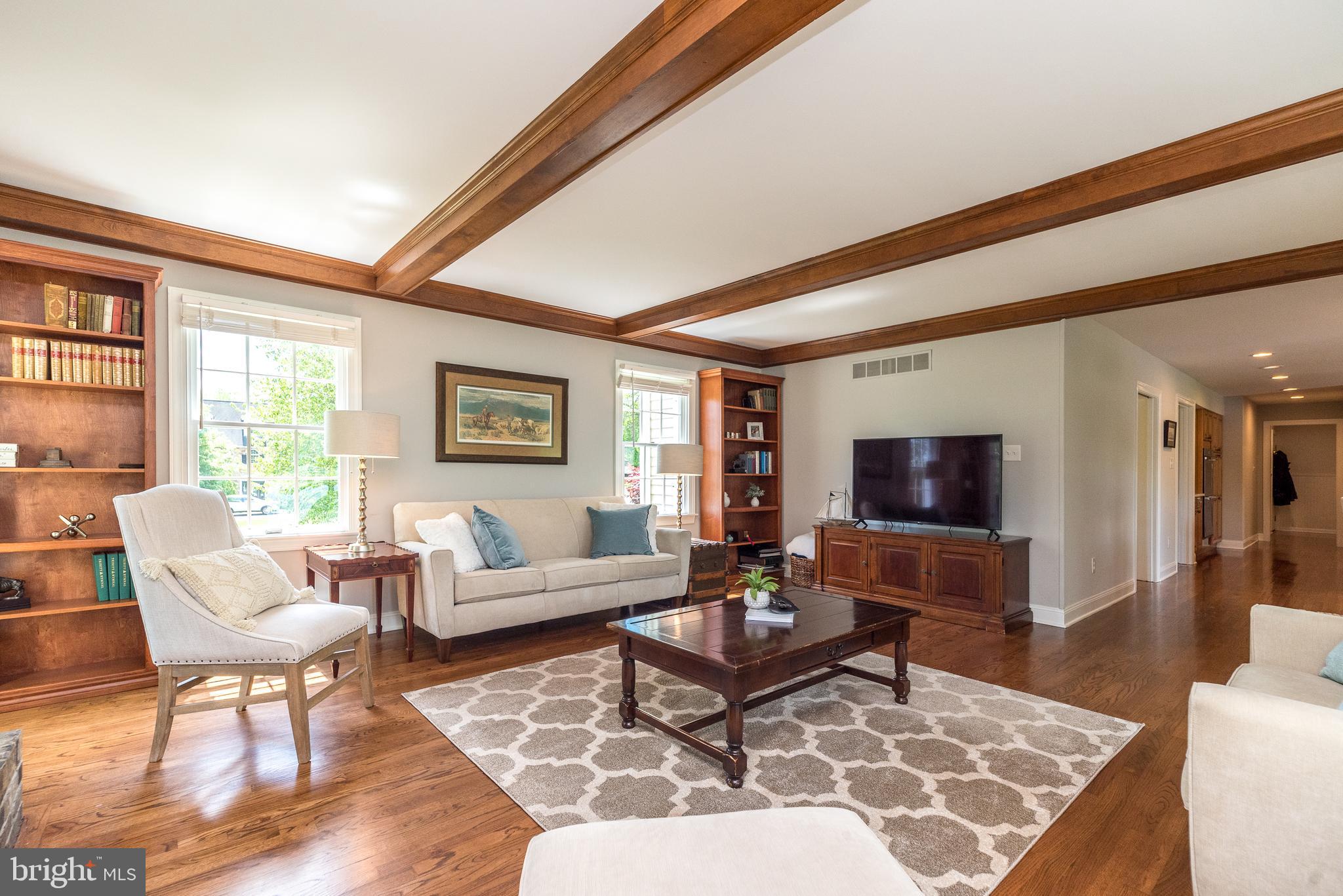 4976 Gloucester Drive Doylestown, PA 18902 - Photo 26 of 68 a living room with furniture a rug and a flat screen tv