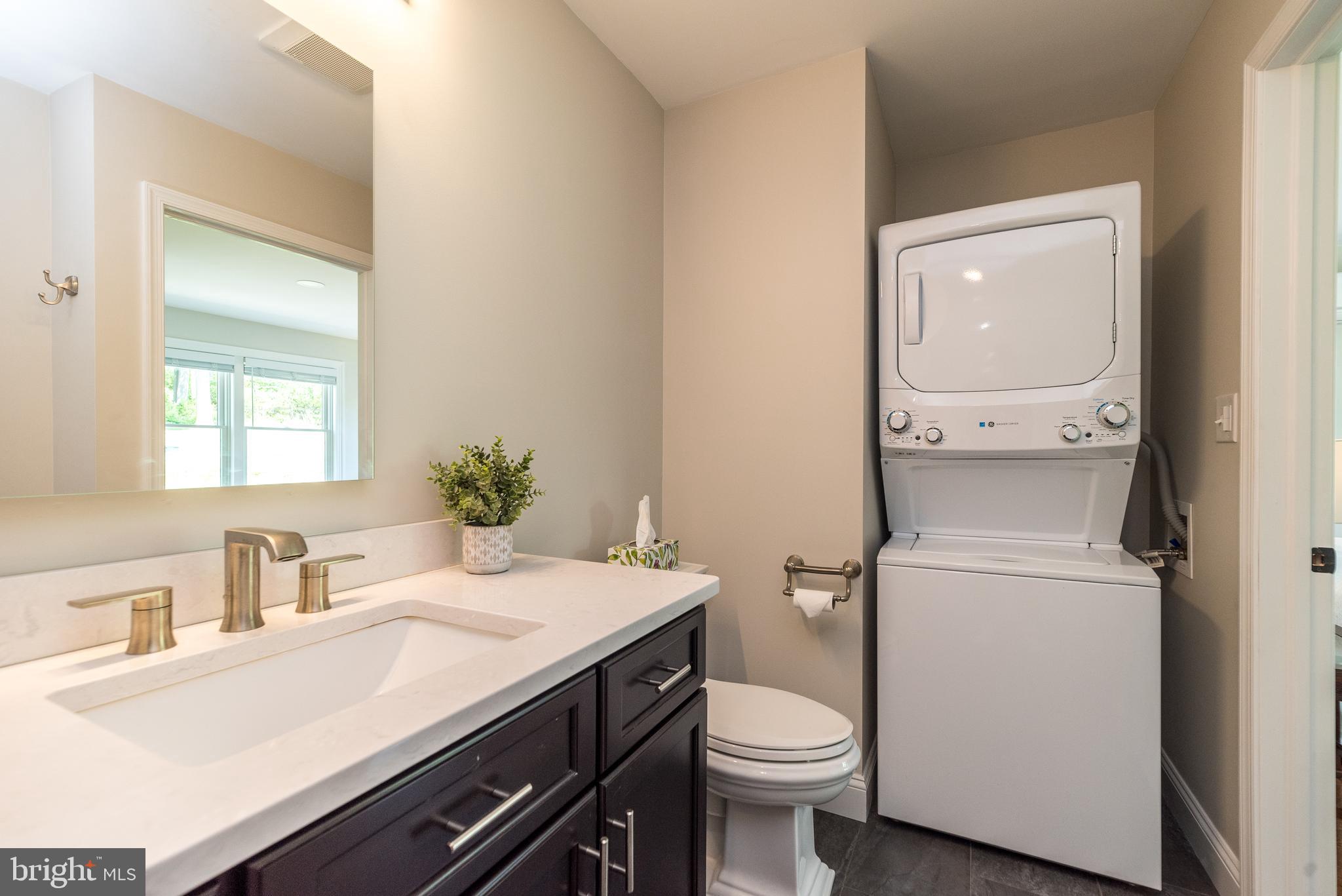 4976 Gloucester Drive Doylestown, PA 18902 - Photo 32 of 68 a bathroom with a sink a toilet and vanity
