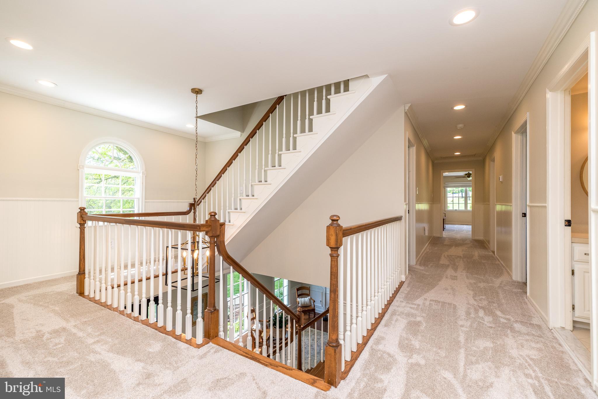 4976 Gloucester Drive Doylestown, PA 18902 - Photo 34 of 68 a view of staircase with lots of frames on wall and a large window