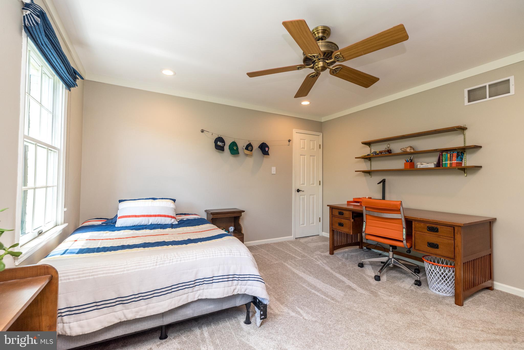 4976 Gloucester Drive Doylestown, PA 18902 - Photo 43 of 68 a bedroom with a bed and a chandelier