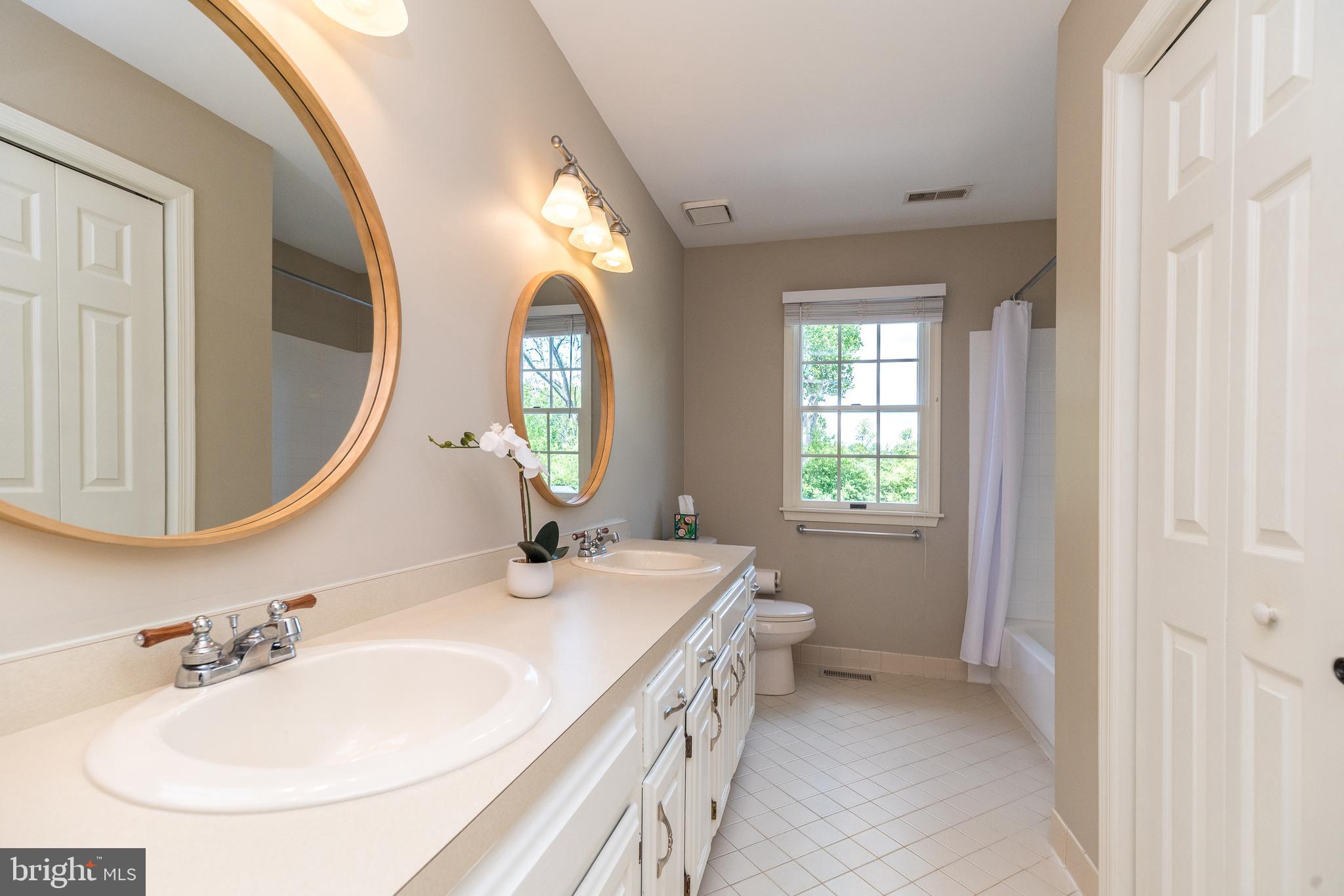 4976 Gloucester Drive Doylestown, PA 18902 - Photo 44 of 68 a bathroom with a sink and a mirror