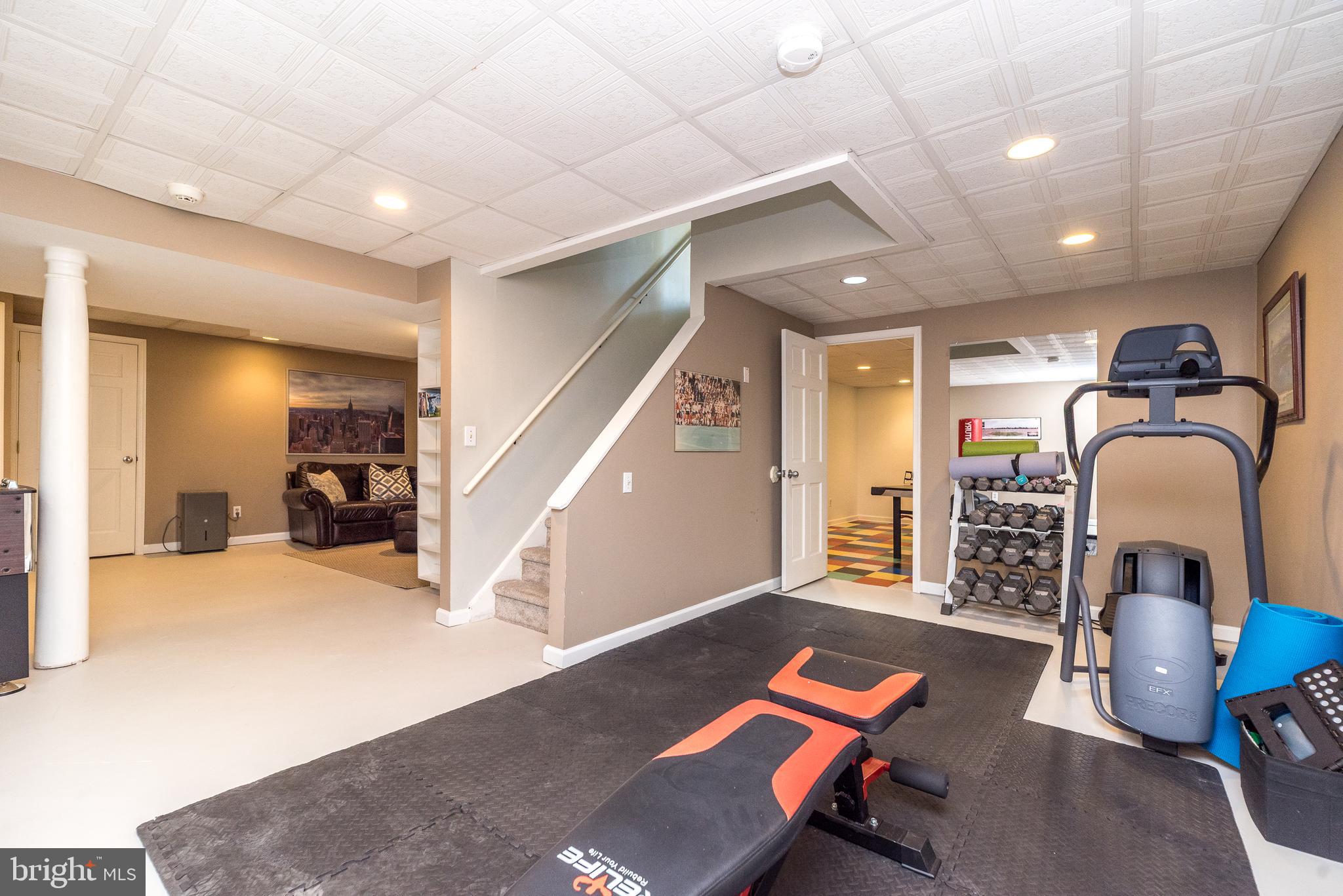 4976 Gloucester Drive Doylestown, PA 18902 - Photo 60 of 68 a living room with furniture and a gym
