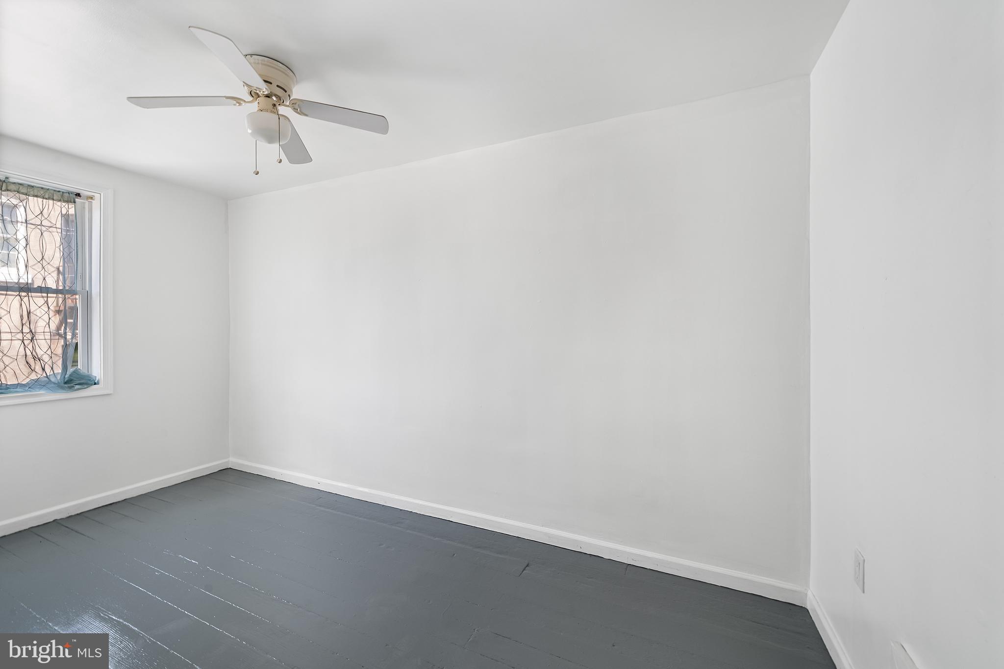 1615 North Philip Street Philadelphia, PA 19122 - Photo 12 of 22 an empty room with a window and a ceiling fan