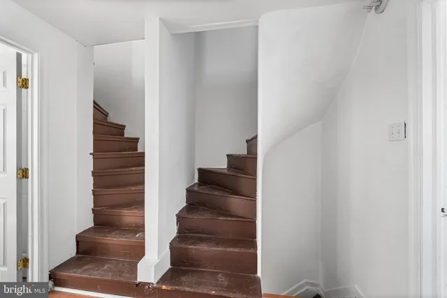 a view of staircase with white walls