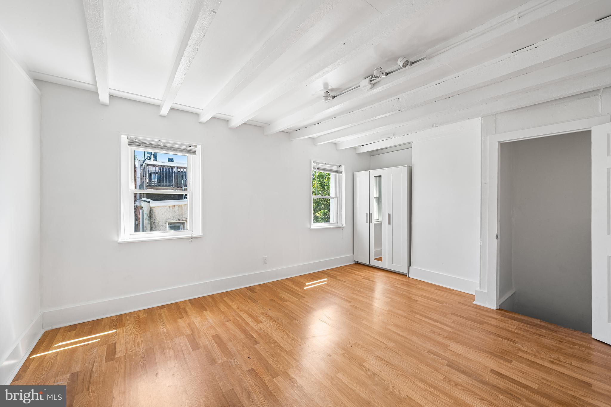 1615 North Philip Street Philadelphia, PA 19122 - Photo 16 of 22 a view of an empty room with wooden floor and a window