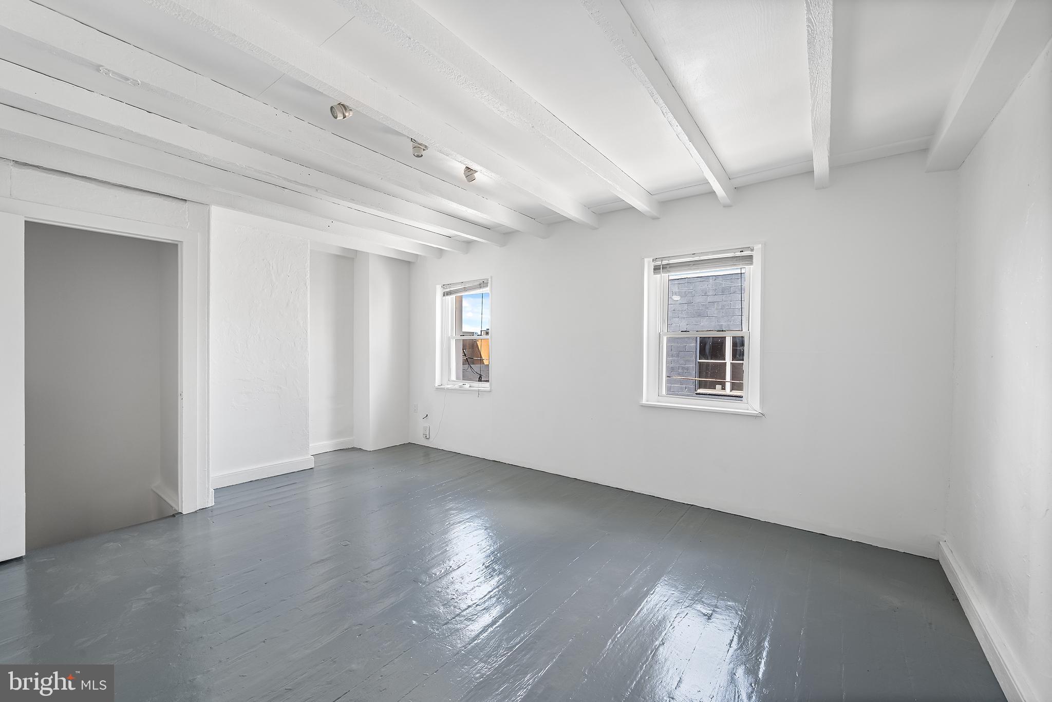 1615 North Philip Street Philadelphia, PA 19122 - Photo 18 of 22 a view of an empty room with wooden floor and a window