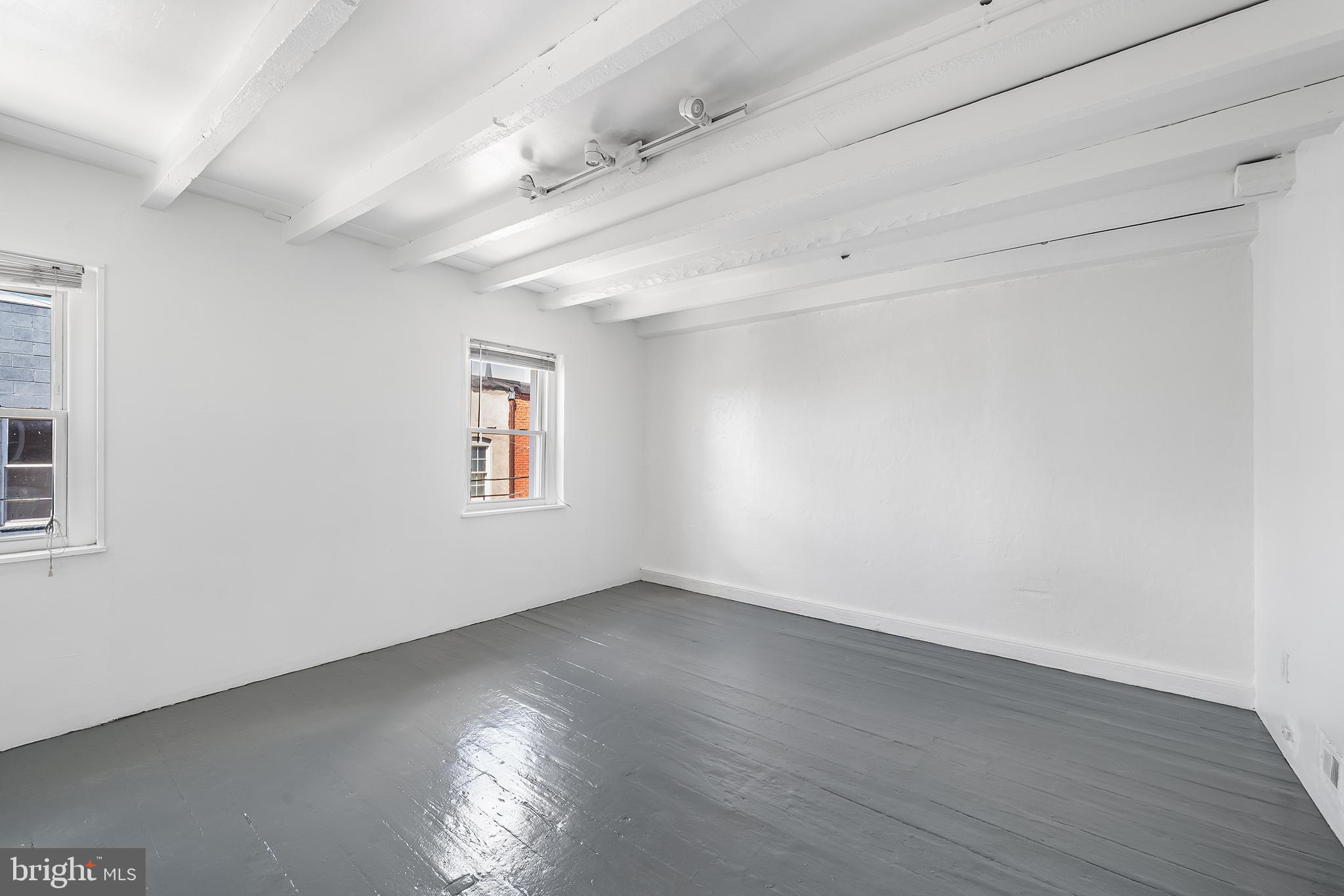 1615 North Philip Street Philadelphia, PA 19122 - Photo 19 of 22 an empty room with wooden floor and windows