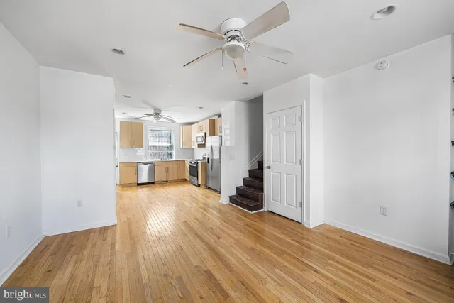 a view of a kitchen with wooden floor and a kitchen space