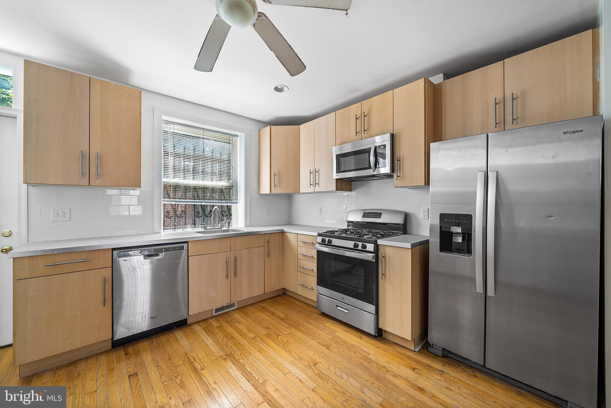 1615 North Philip Street Philadelphia, PA 19122 - Photo 4 of 22 a kitchen with stainless steel appliances granite countertop a stove a sink dishwasher a refrigerator and a microwave oven