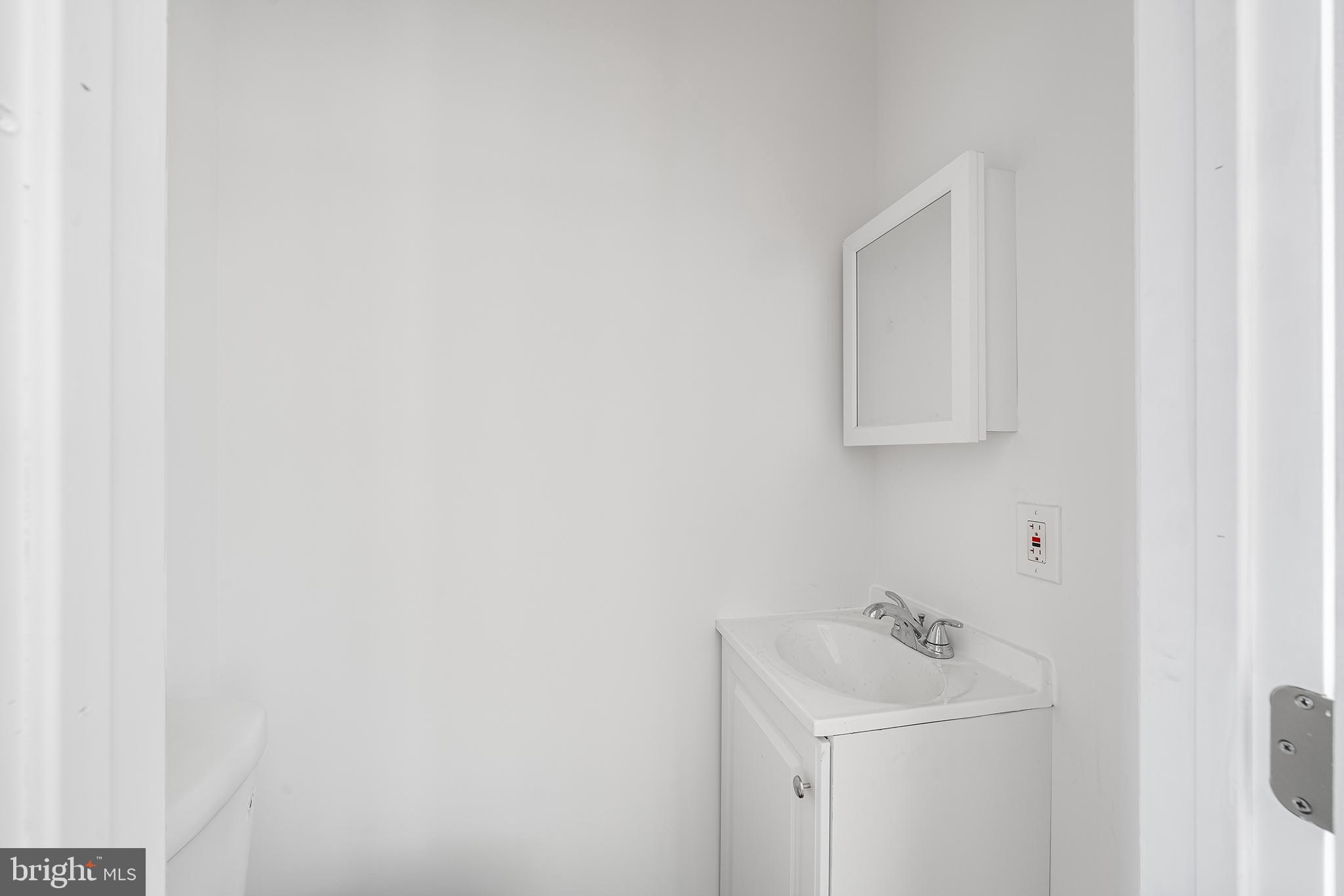1615 North Philip Street Philadelphia, PA 19122 - Photo 6 of 22 a bathroom with a sink a toilet and mirror