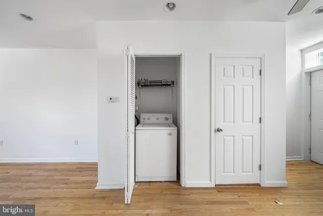 a view of a room with wooden floor