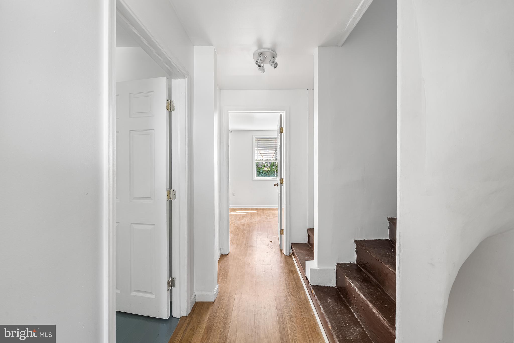 1615 North Philip Street Philadelphia, PA 19122 - Photo 8 of 22 a view of a hallway with wooden floor and a bathroom