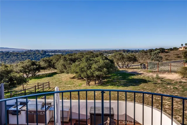 a kitchen with stainless steel appliances granite countertop a stove top oven a sink a dining table and chairs