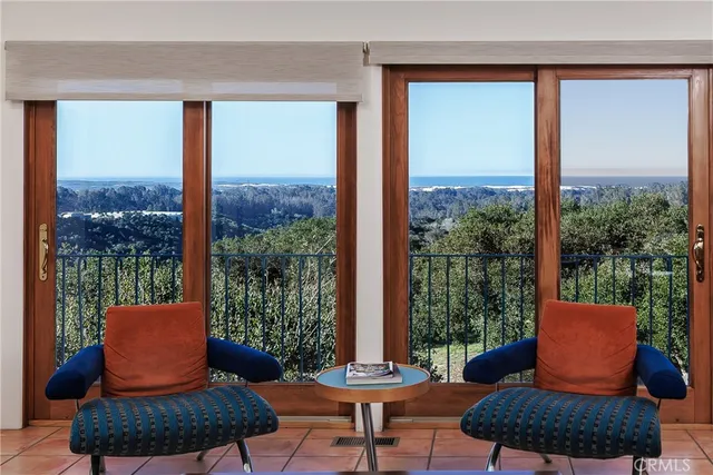 an aerial view of a backyard of a house with a table & chairs