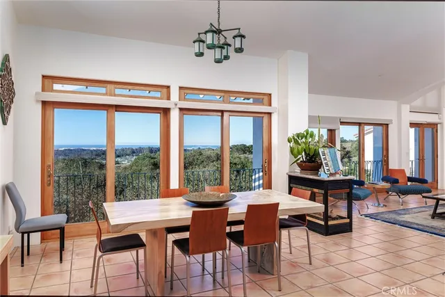 a living room with furniture a floor to ceiling window and a flat screen tv