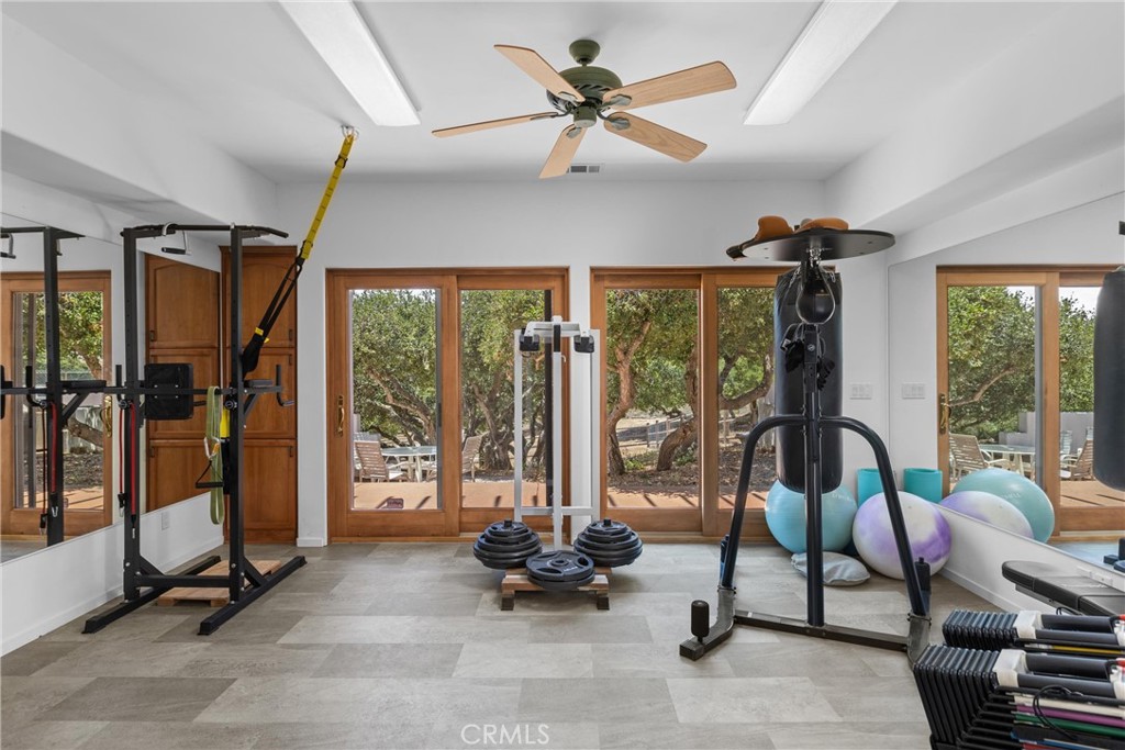 1790 Calle Laguna Arroyo Grande, CA 93420 - Photo 34 of 53 a living room with furniture a floor to ceiling window and a flat screen tv