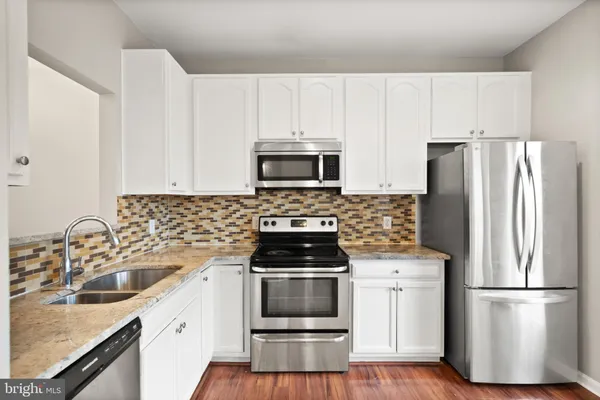 a kitchen with a sink stove and refrigerator