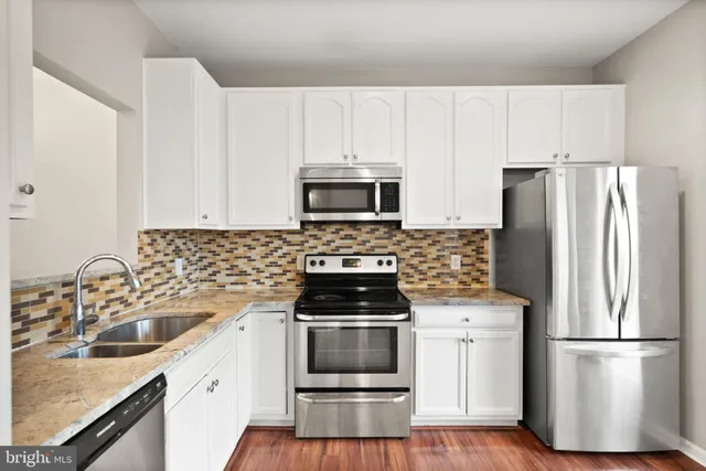 a kitchen with a sink stove and refrigerator