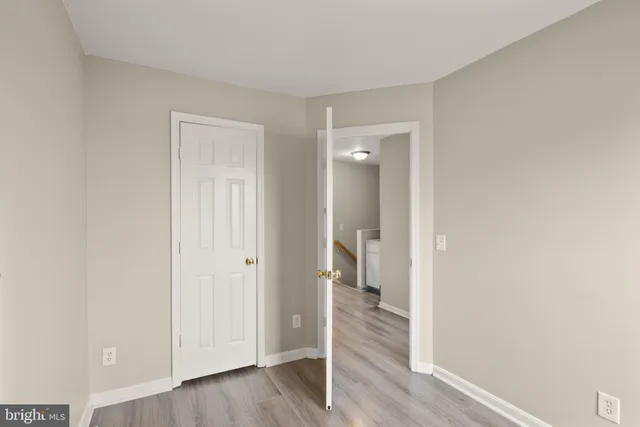 a view of a room with wooden floor