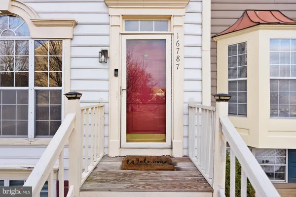 a view of front door of house with stairs