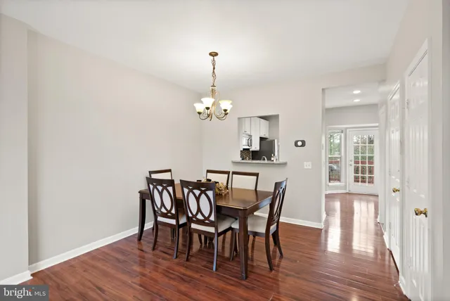 a view of a dining room with furniture wooden floor and chandelier