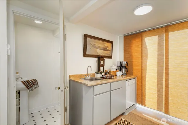 a view of a chair and table in backyard of the house