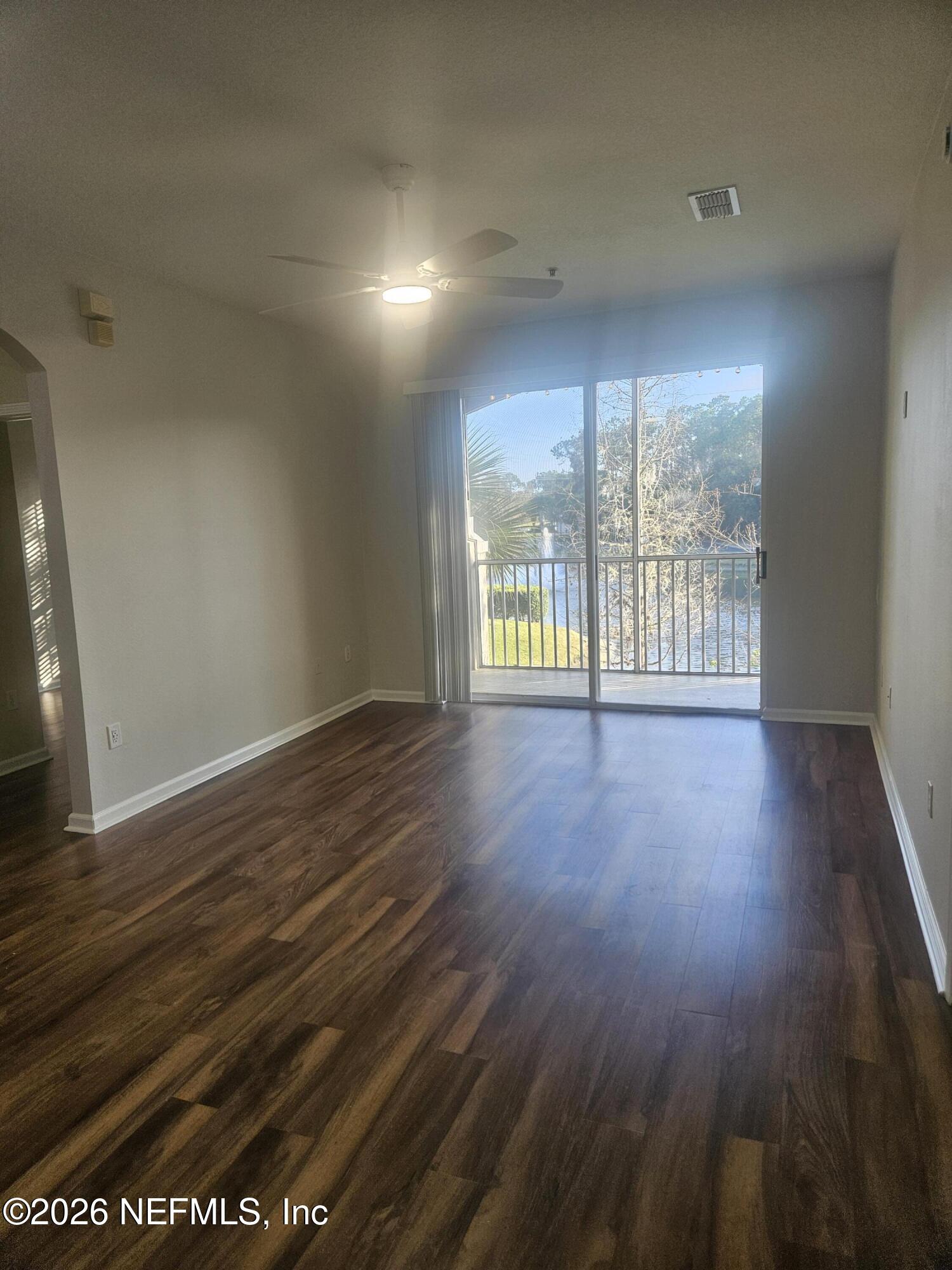 10550 Baymeadows Road, Unit 323 Jacksonville, FL 32256 - Photo 11 of 50 an empty room with wooden floor and windows