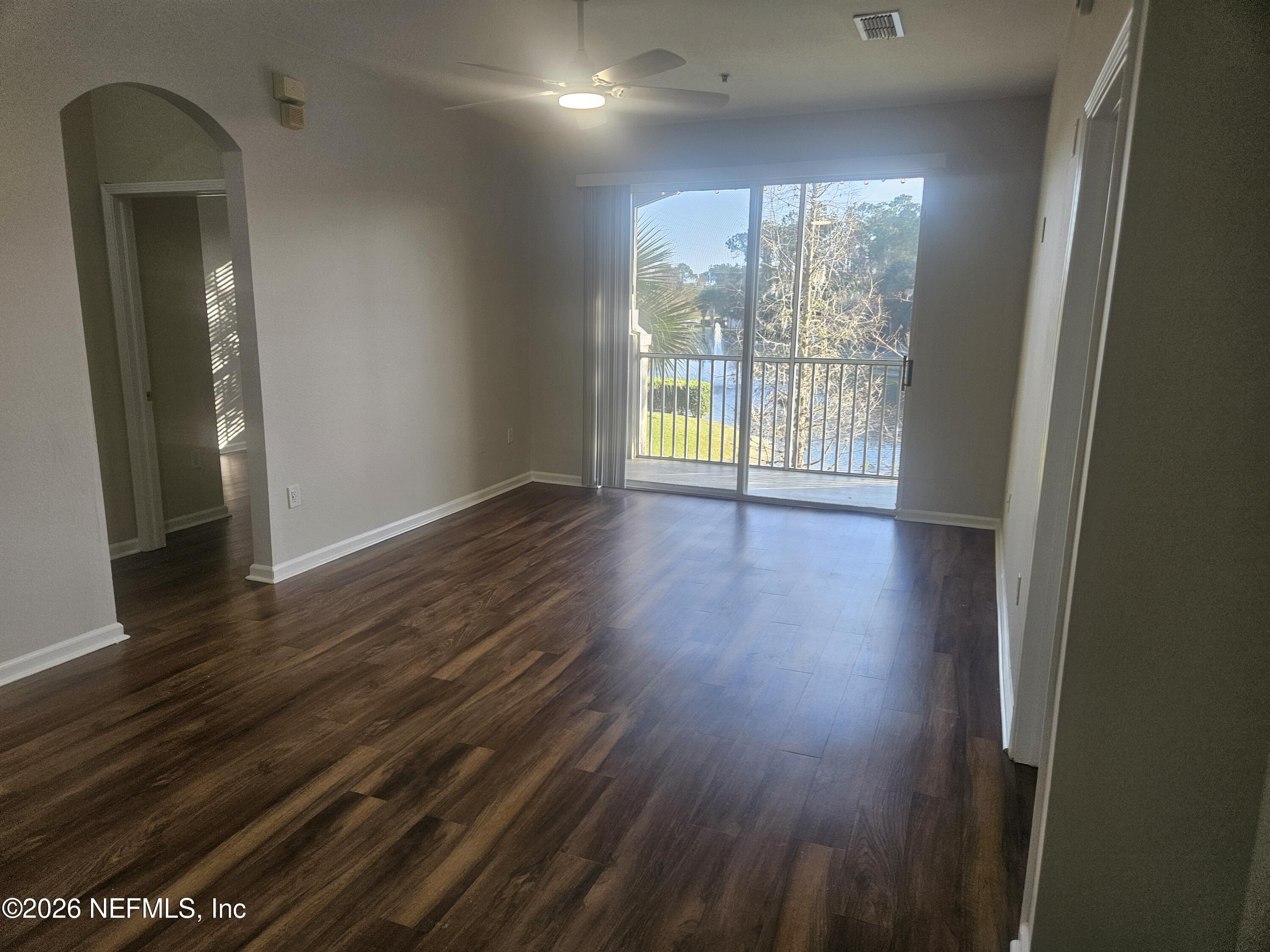 10550 Baymeadows Road, Unit 323 Jacksonville, FL 32256 - Photo 12 of 50 a view of an empty room with wooden floor and a window