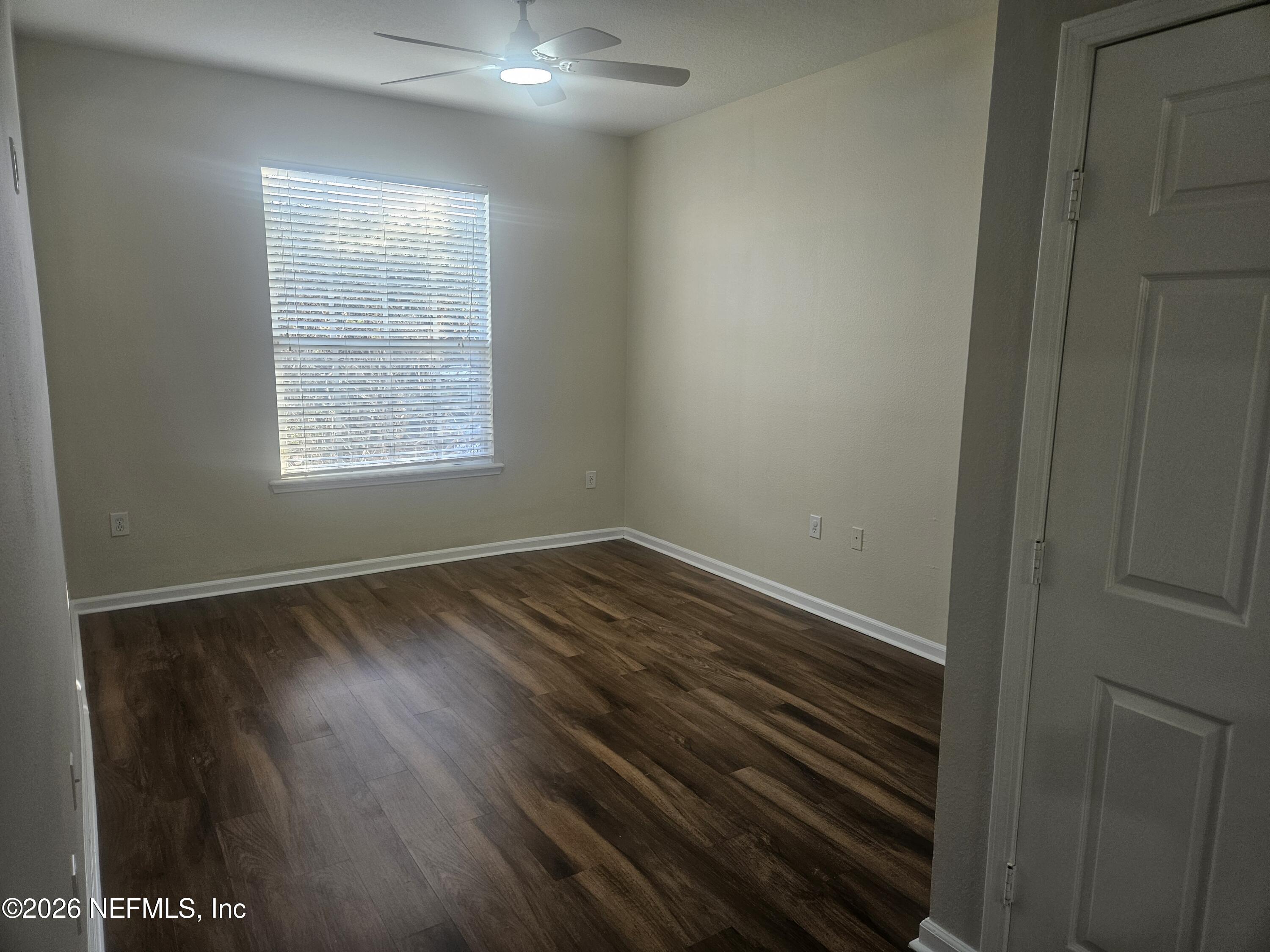 10550 Baymeadows Road, Unit 323 Jacksonville, FL 32256 - Photo 19 of 50 a view of an empty room with wooden floor and a window