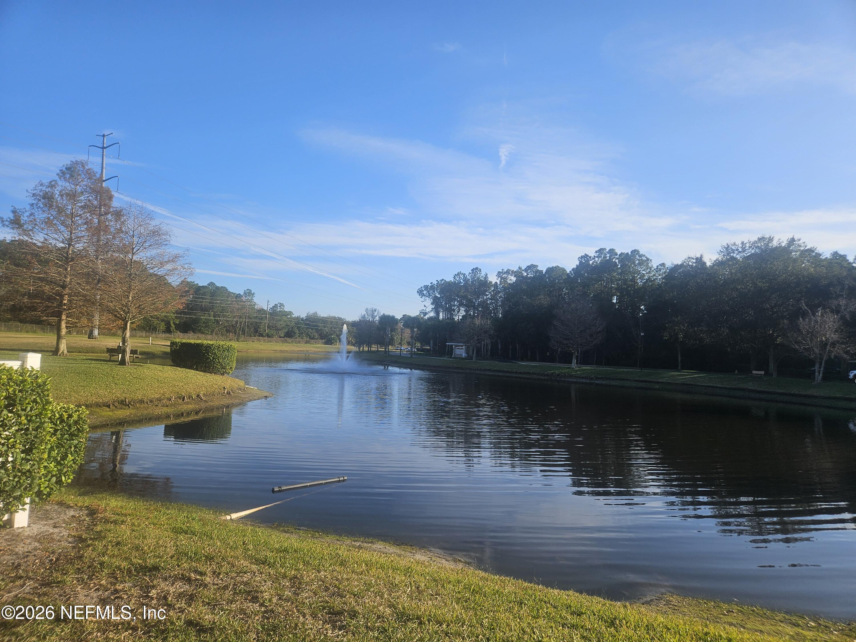 10550 Baymeadows Road, Unit 323 Jacksonville, FL 32256 - Photo 27 of 50 a view of a lake with a yard