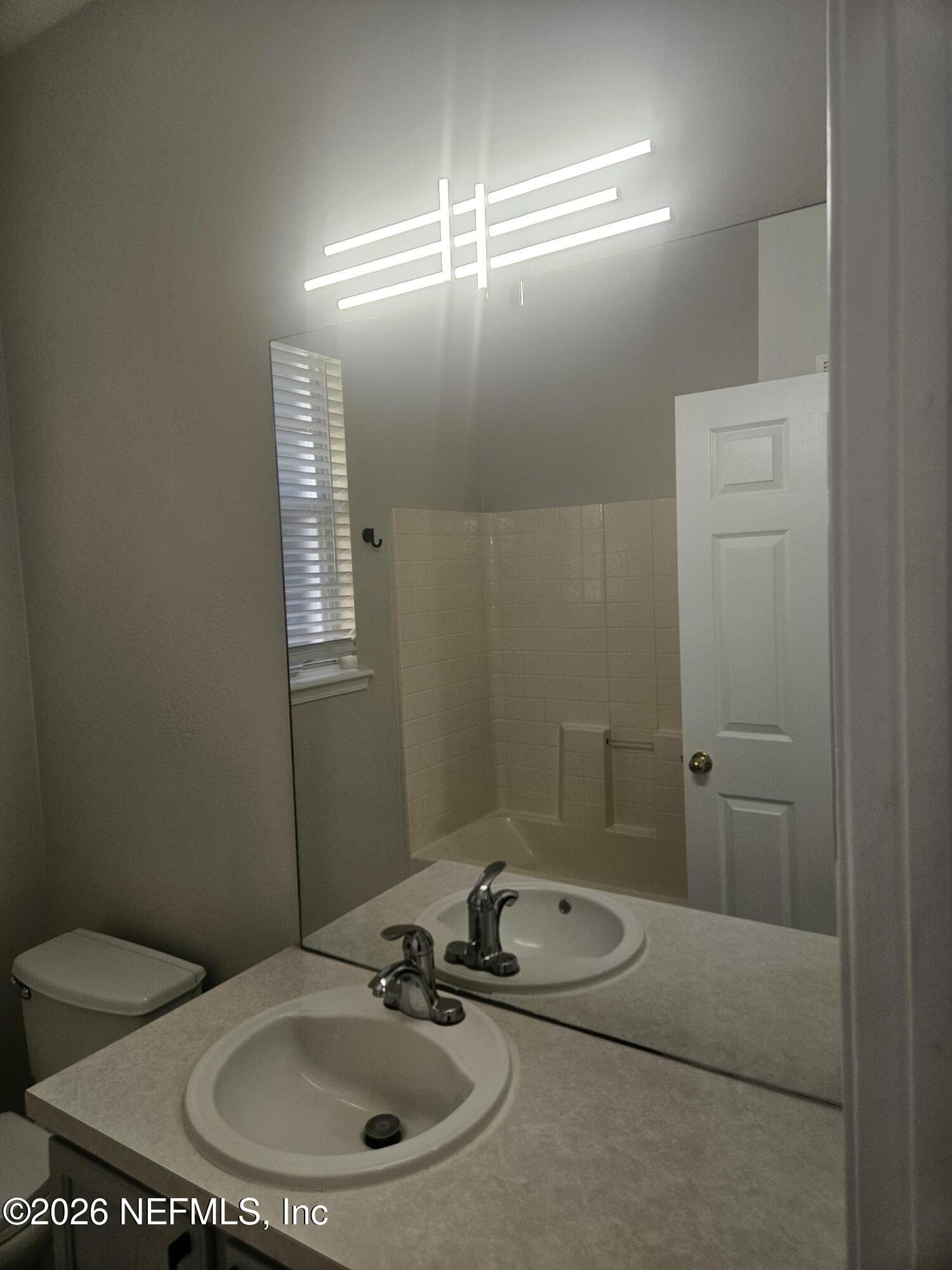 10550 Baymeadows Road, Unit 323 Jacksonville, FL 32256 - Photo 32 of 50 a bathroom with a sink toilet and a mirror
