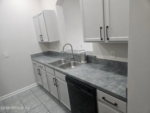 a kitchen with stainless steel appliances granite countertop a sink dishwasher and cabinets