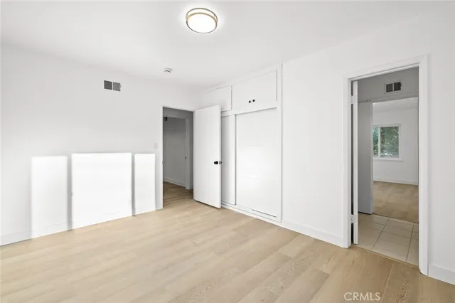 a white toilet sitting next to a shower