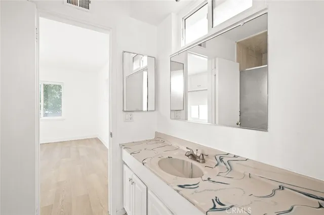 a view of an empty room with wooden floor