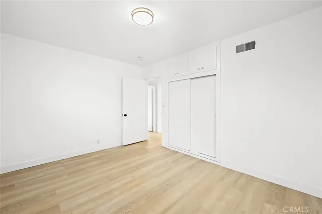 a white toilet sitting next to a bathroom sink and a shower