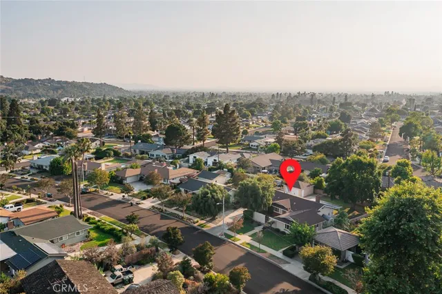 an aerial view of house with yard and mountain view in back